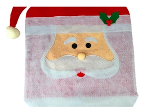 Close-up of Santa Claus chair cover with holly berry detail and white fuzzy pom-pom decor