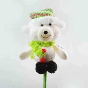 Detail of Christmas polar bear topper with red-green knit hat and green scarf on stick