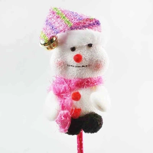 Detailed view of a Christmas snowman plush topper with pink scarf and golden bell