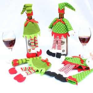 Detail of elf-themed Christmas wine bottle covers with green polka dots and stripes