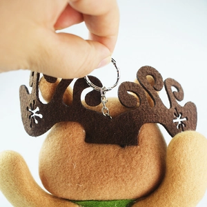 Detail of reindeer plush keychain showing brown felt antlers and metal clasp closure
