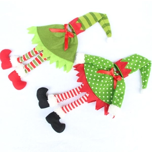 Detail of elf wine bottle covers with red green stripes and festive felt ornaments