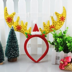 Christmas headband with large gold sequined antlers, red mini hat and festive ornaments
