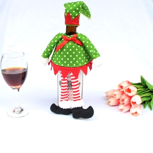 Detail of elf wine bottle cover with green polka dots and red-white striped legs