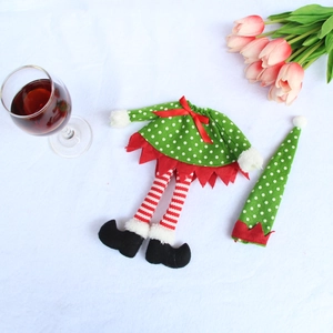 Detail view of green elf wine bottle cover with polka dots and red stripe legs