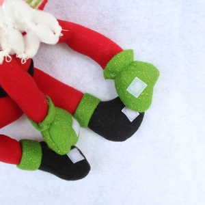 Detailed close-up of sequined felt fabric and velcro fasteners on Christmas bottle cover