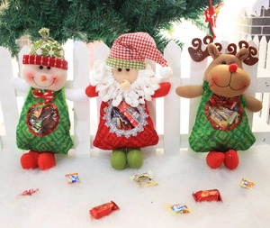Detailed view of Christmas candy bags featuring plush Santa, Snowman and Reindeer characters