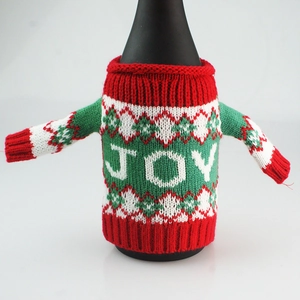 Close-up of JOY knit Christmas wine bottle cover with ribbed neck and festive patterns