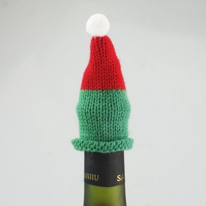 Detailed view of red and green knitted Christmas mini hat decor for wine bottle tops