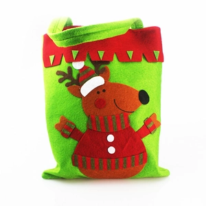 Close-up of green felt Christmas reindeer gift bag with red zigzag trim and striped scarf