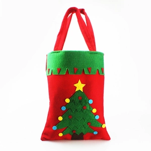 Detail of red and green felt Christmas gift bag featuring a festive 3D Christmas tree patch