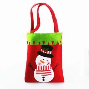 Detail of red Christmas felt gift bag featuring 3D snowman patch and green trim