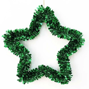Detail of a green tinsel star wreath with a metallic finish and a gold hanging string