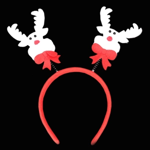 Detail of red Christmas headband with white reindeer antlers and spring bow accents
