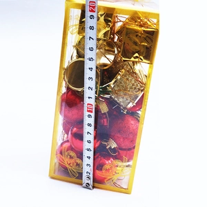 Detailed view of 20cm Christmas ornament box with red balls and small golden drums