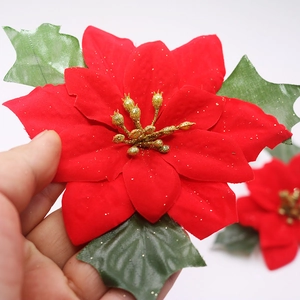 Red flocked Christmas Poinsettia flower with gold glitter and green leaves decoration