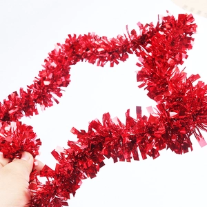 Detail of a shiny red Christmas tinsel garland with a glossy metallic finish for parties