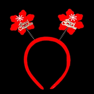 Detail of red spring headband with Merry Christmas snowflake decorations for party