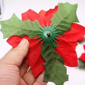 Red poinsettia Christmas flower with green leaves for tree decoration and DIY crafts