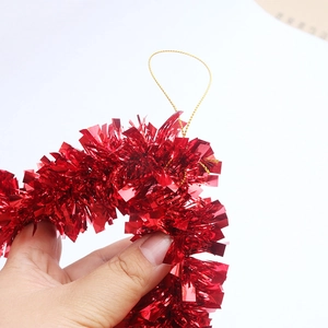 Close-up of a festive 35cm red metallic tinsel garland with a golden hanging string