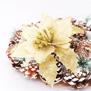 Detail of 15cm gold glitter poinsettia flower with natural pine cones for Christmas decor