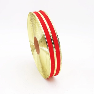Close-up of 5cm red linen ribbon with parallel gold metallic stripes for gift wrapping