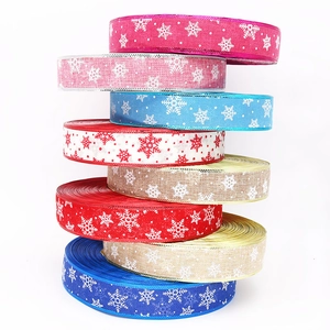 Stack of colorful Christmas burlap ribbons with snowflake prints for festive DIY wreaths