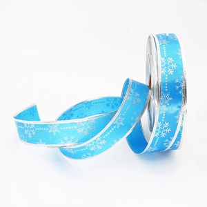 Light blue satin Christmas ribbon with silver snowflake print and metallic edges for gift DIY