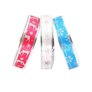 Red, white, and blue Christmas ribbons with silver glitter reindeer and snowflake patterns