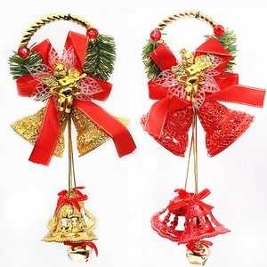 Detailed view of red and gold Christmas bell ornaments with angel statues and bows
