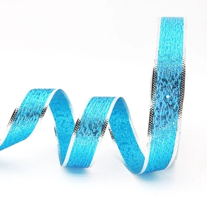 Close-up of bright blue glitter ribbon with silver polka dot edges for gift wrapping