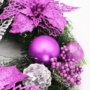 Detail of Christmas wreath with purple hollow flowers, glitter berries and silver pine cones