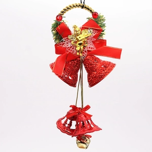 Detailed view of red glitter bells with golden angel and festive ribbon on white background