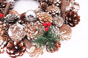 Detailed close-up of 37cm white pine cone Christmas wreath with cinnamon sticks and berries