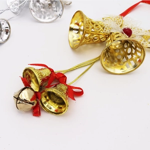 Detail of Christmas bell wreath with golden镂空bells and red ribbon bow decorations