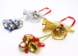 Close-up of gold and silver Christmas bells with colorful bows and lace for tree decor