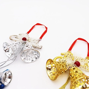 Detail of gold and silver Christmas bells with hollow star patterns and lace ribbon