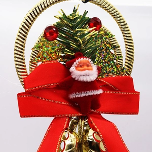 Detail of red Santa figurine with large bow and golden metal bells hanging on a ring