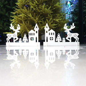 Detailed view of white Christmas silhouette set with deer, house, and trees on reflection