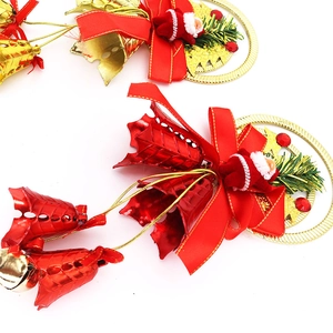 Detail of red Santa Claus bell ornament with bow and berries for Christmas tree