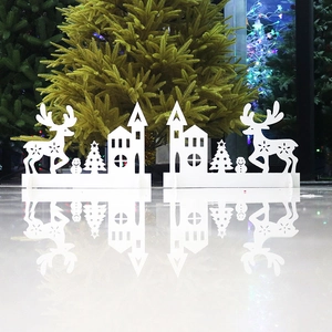 Detailed white silhouette Christmas ornaments featuring deer, houses and trees on a stand
