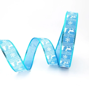Light blue Christmas ribbon with white reindeer and snowflake prints for holiday decor
