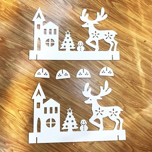 Detail of white PVC Christmas fence featuring reindeer, snowman and tree silhouette