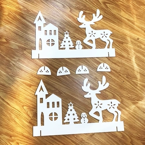 White Christmas house and reindeer fence decorations with snowflake cutout patterns