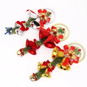 Close-up of metallic Christmas bells with silk bows and pine needle festive decorations