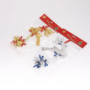 Detail of gold and silver Christmas reindeer ornaments with small bells and silk bows
