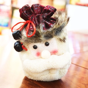 Detailed view of handmade Santa gift bag with plush trim and small metal bells