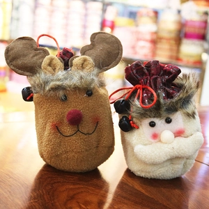 Detail of Christmas candy bags featuring reindeer and Santa Claus with plush fabric and bells