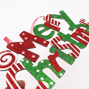 Macro shot of glittery Merry Christmas sign with festive stars and polka dot patterns