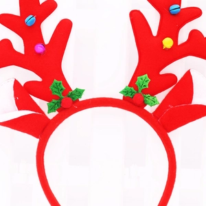 Close-up of red reindeer antler headband with colorful bells and holly for Christmas